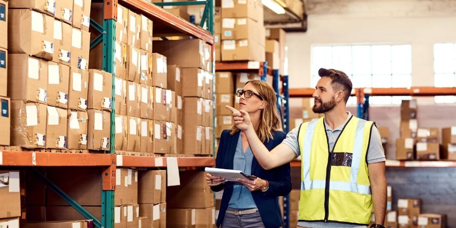 Facility manager and worker looking over inventory