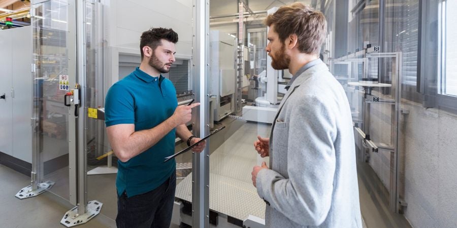 2 workers talking about the equipment