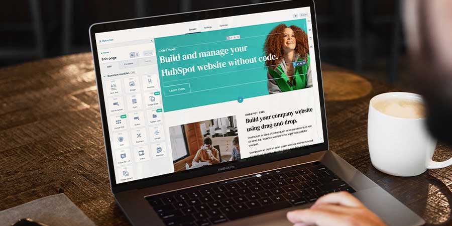 Laptop sitting on a desk with HubSpot CMS Hub editor pulled up