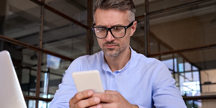 Man With Glasses On His Phone