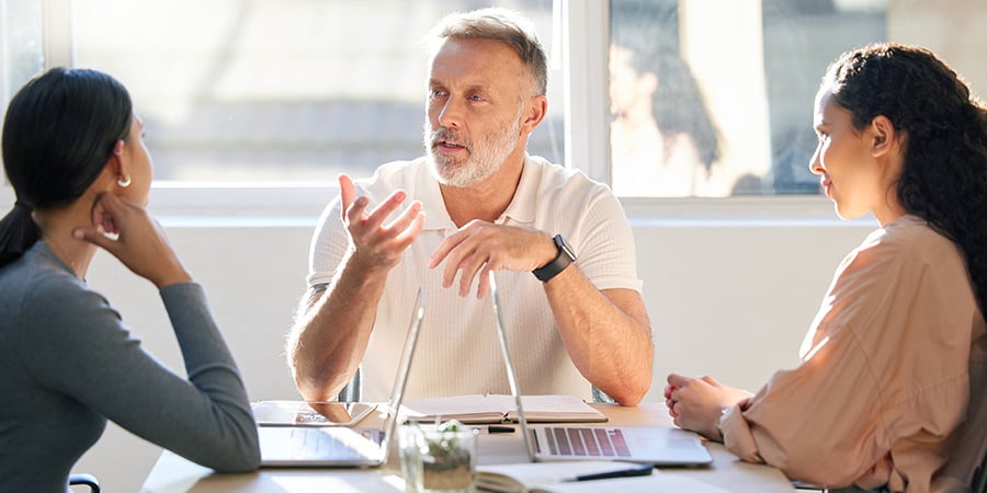 Manager Talking To Two Females In Meeting