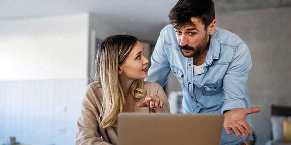 Woman And Man Disccusing Computer Screen With Urgency