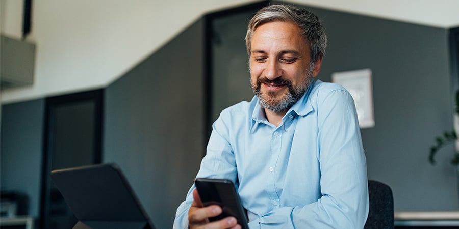 Happy male looking at his phone